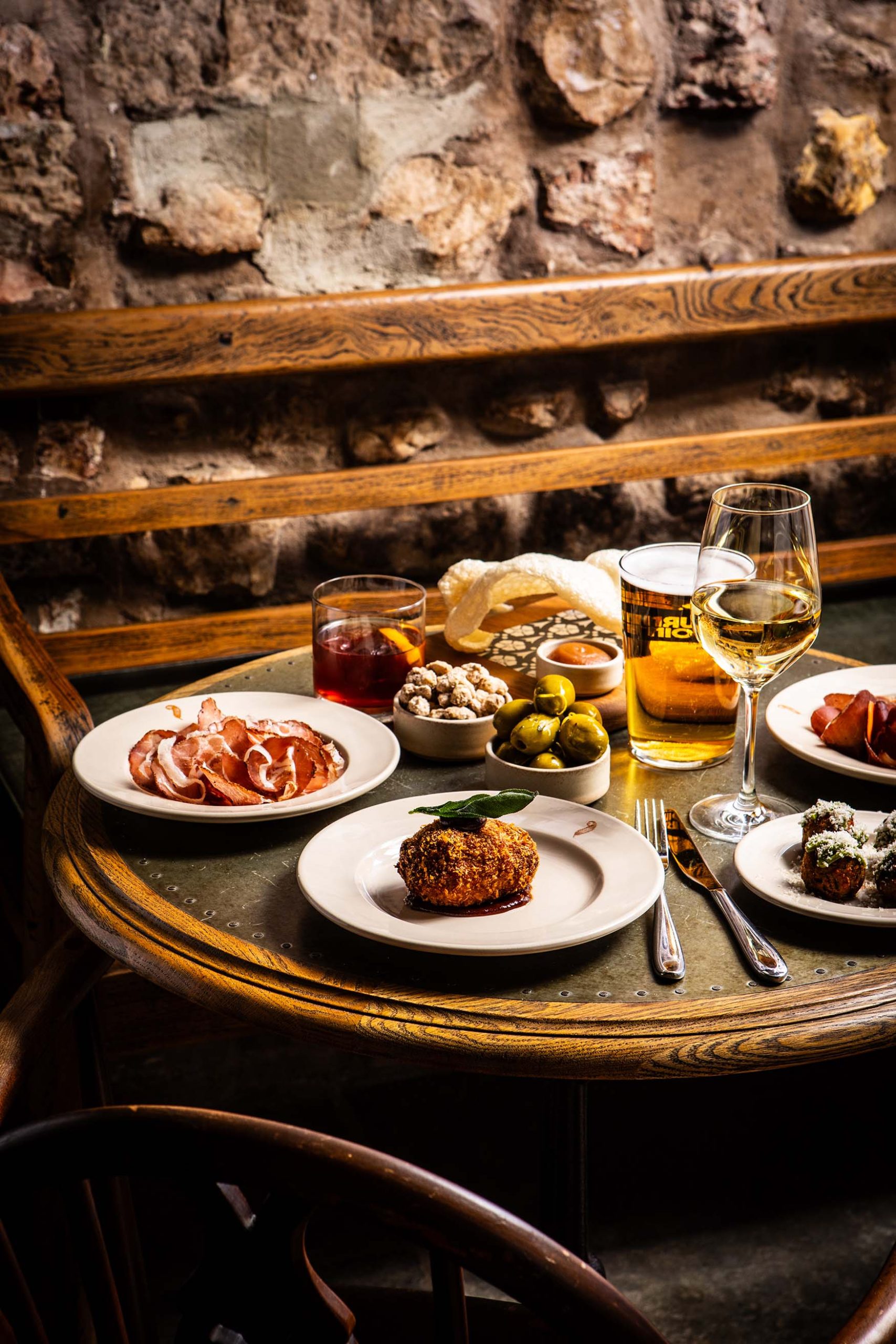 A collection of bar snacks on a table at the bar in The General Tarleton