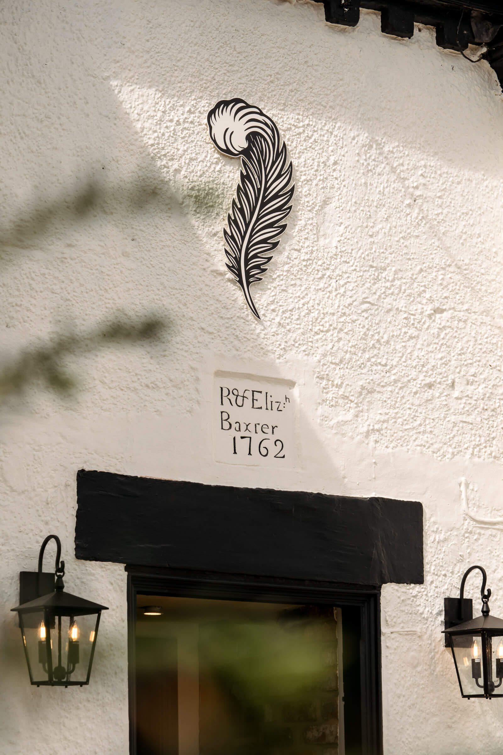 Front door of The General Tarleton with the feather logo above the door